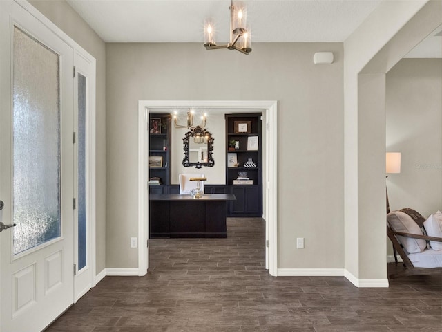 4806 NW 8th Ter, Ocala, FL 34475 - foyer entrance featuring baseboards, dark wood-style flooring, and a chandelier