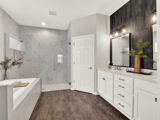 4806 NW 8th Ter, Ocala, FL 34475 - full bathroom featuring vanity, a marble finish shower, wood finished floors, visible vents, and a bath