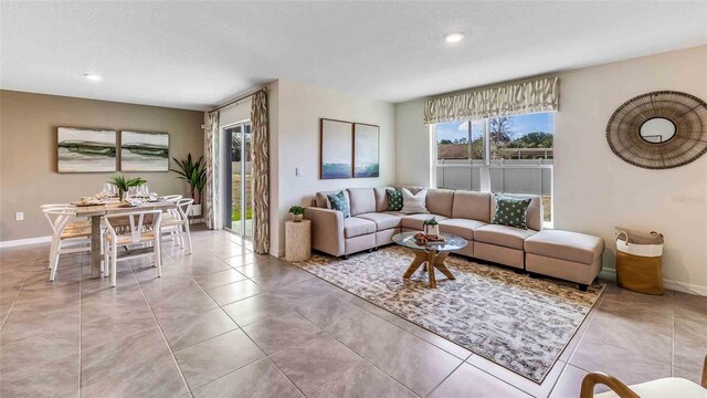 living area featuring recessed lighting, light tile patterned flooring, and baseboards