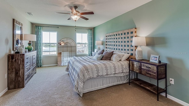 carpeted bedroom featuring a ceiling fan and baseboards