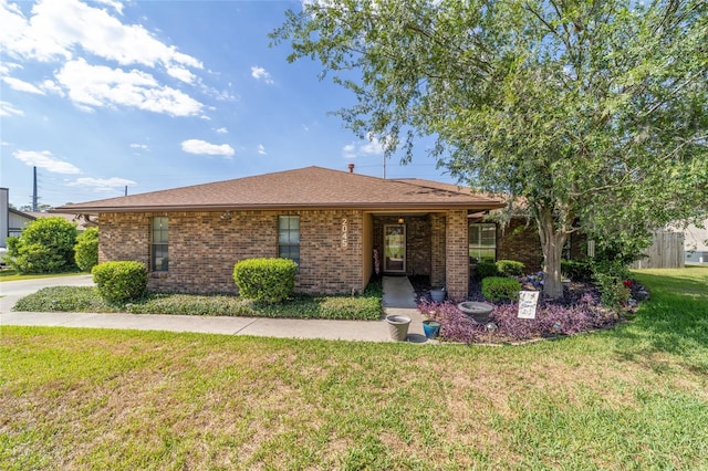 2045 SE 32nd St, Ocala, FL 34471 - ranch-style house featuring a front lawn, brick siding, and roof with shingles
