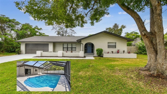 back of property with fence, an attached garage, stucco siding, concrete driveway, and a lawn