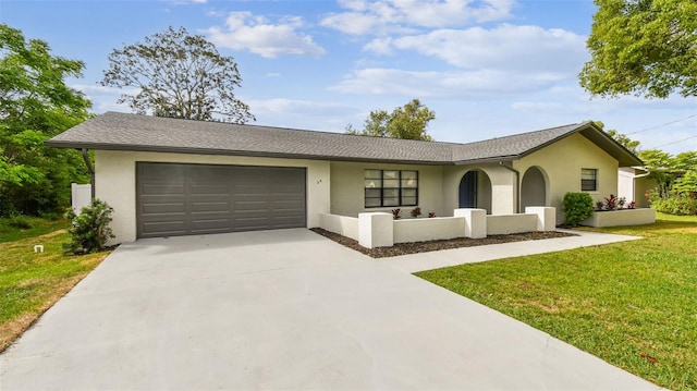 ranch-style house with an attached garage, a front lawn, driveway, and stucco siding