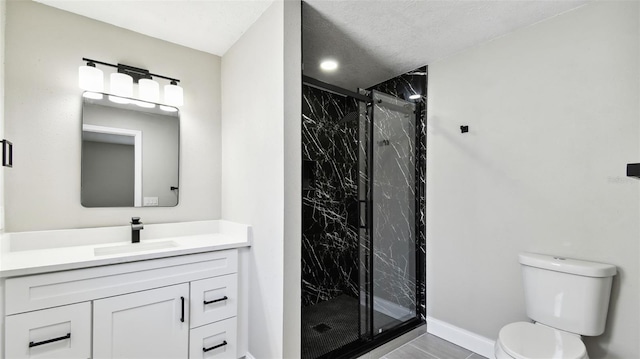 bathroom featuring toilet, baseboards, a marble finish shower, and vanity