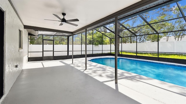 view of swimming pool with fence, ceiling fan, a fenced in pool, a patio, and glass enclosure