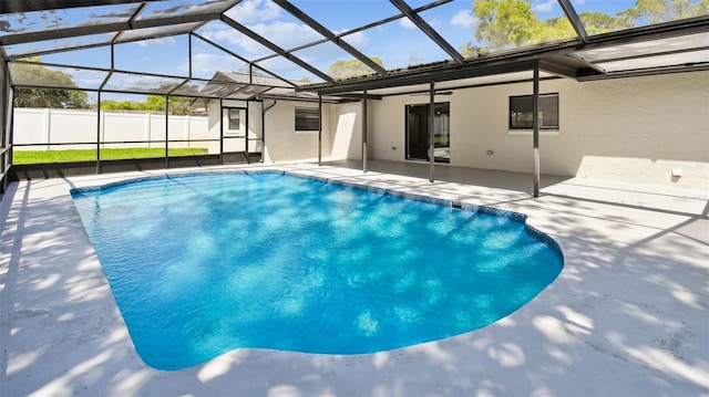 view of swimming pool featuring a patio, a lanai, a fenced in pool, and fence