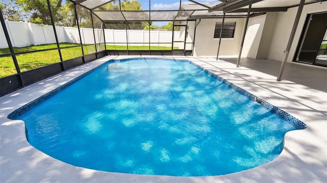 view of pool with glass enclosure, a patio, fence, and a fenced in pool