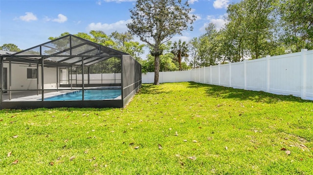 view of yard with a fenced in pool, a lanai, a fenced backyard, and a patio area