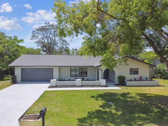 ranch-style house with stucco siding, driveway, a front yard, and a garage
