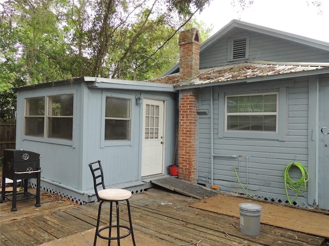 219 SE 3rd Ave, Williston, FL 32696 - rear view of house with a deck and a chimney