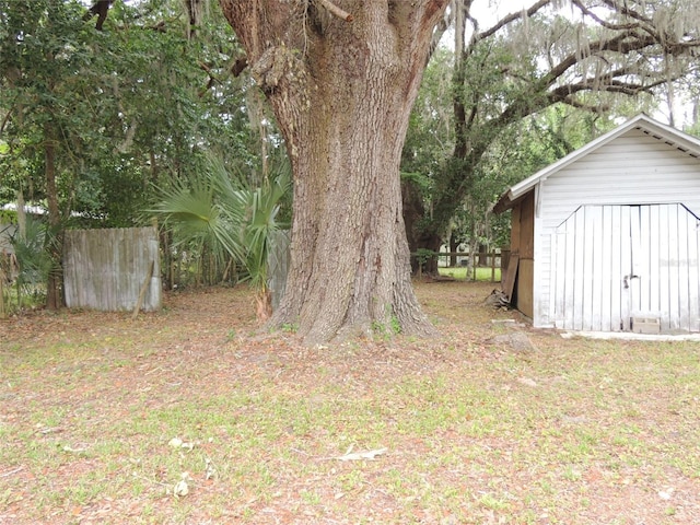 219 SE 3rd Ave, Williston, FL 32696 - view of yard with a storage unit, fence, and an outdoor structure