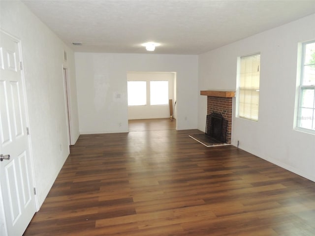 219 SE 3rd Ave, Williston, FL 32696 - unfurnished living room featuring wood finished floors and a healthy amount of sunlight