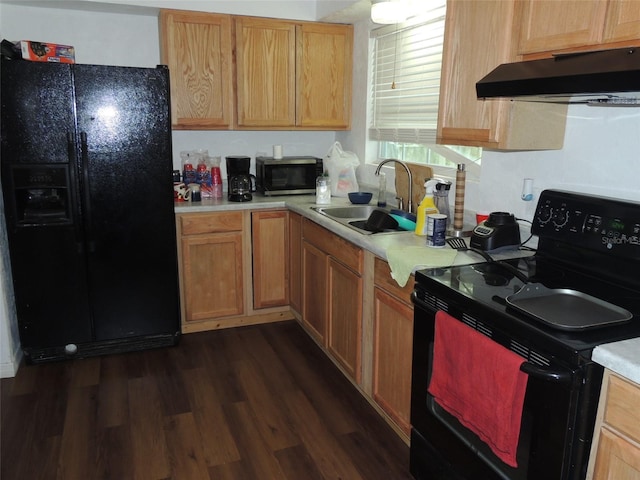 219 SE 3rd Ave, Williston, FL 32696 - kitchen with black appliances, a sink, under cabinet range hood, and light countertops