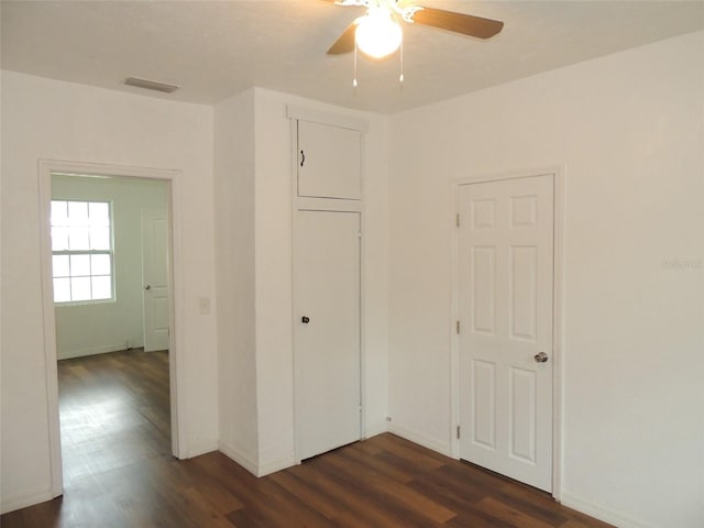 219 SE 3rd Ave, Williston, FL 32696 - unfurnished bedroom with visible vents, a ceiling fan, dark wood finished floors, and baseboards