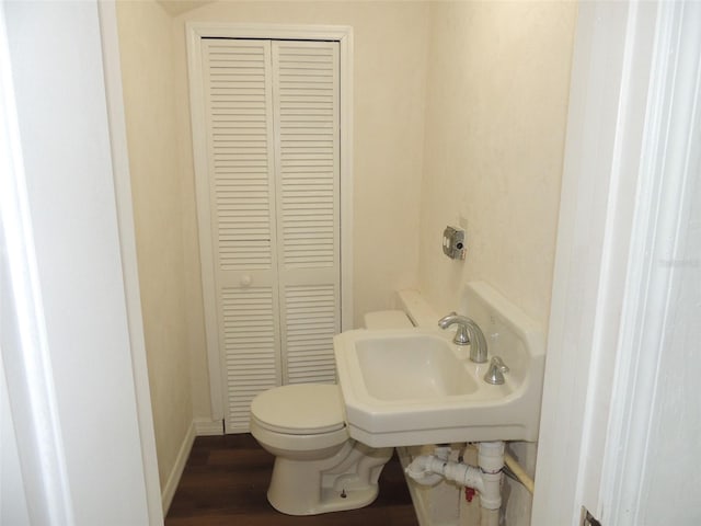 219 SE 3rd Ave, Williston, FL 32696 - bathroom featuring wood finished floors, a closet, toilet, a sink, and baseboards