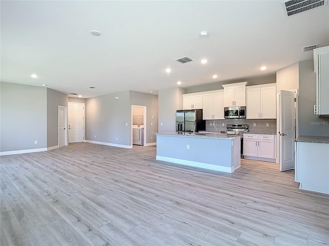 2423 Sadnet Ln, North Port, FL 34286 - kitchen with visible vents, appliances with stainless steel finishes, open floor plan, and baseboards