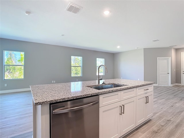 2423 Sadnet Ln, North Port, FL 34286 - kitchen with stainless steel dishwasher, a sink, light wood-style floors, and visible vents