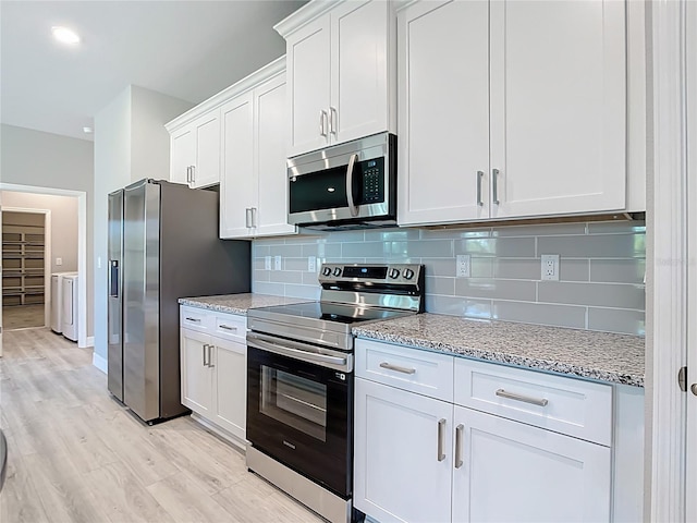 2423 Sadnet Ln, North Port, FL 34286 - kitchen featuring light stone countertops, white cabinets, stainless steel appliances, and decorative backsplash