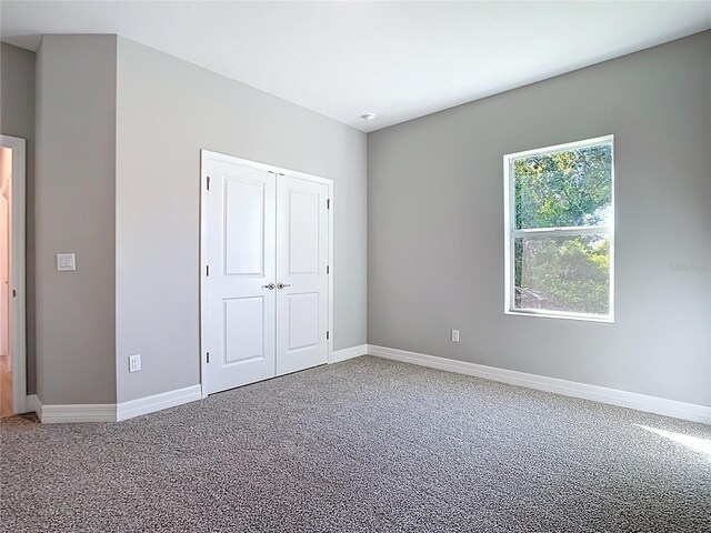 2423 Sadnet Ln, North Port, FL 34286 - unfurnished bedroom featuring a closet, carpet flooring, and baseboards