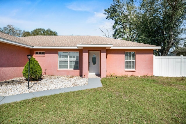 13425 SW 106th Pl, Dunnellon, FL 34432 - ranch-style home with stucco siding, roof with shingles, fence, and a front yard