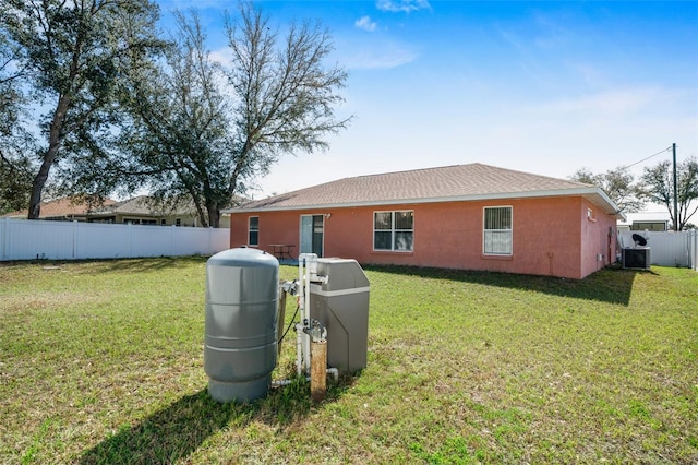 13425 SW 106th Pl, Dunnellon, FL 34432 - back of property with fence, central air condition unit, stucco siding, and a yard