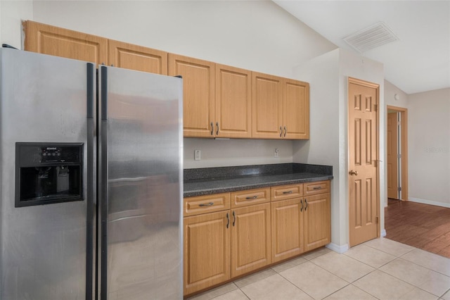 13425 SW 106th Pl, Dunnellon, FL 34432 - kitchen featuring visible vents, dark countertops, light tile patterned floors, baseboards, and stainless steel fridge