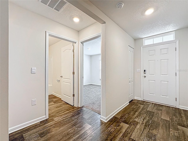 19 Roxland Ln, Palm Coast, FL 32164 - foyer with wood finished floors, baseboards, a textured ceiling, and visible vents