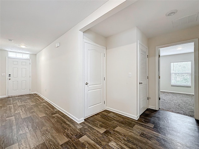 19 Roxland Ln, Palm Coast, FL 32164 - corridor featuring baseboards, dark wood-style floors, and visible vents