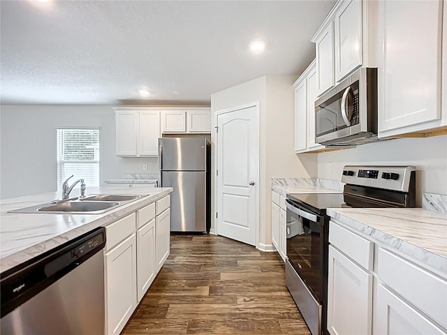 19 Roxland Ln, Palm Coast, FL 32164 - kitchen featuring a sink, light countertops, stainless steel appliances, white cabinetry, and dark wood-style floors