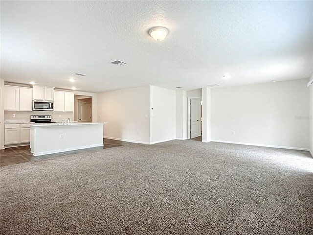 19 Roxland Ln, Palm Coast, FL 32164 - unfurnished living room featuring visible vents, a sink, baseboards, and carpet floors