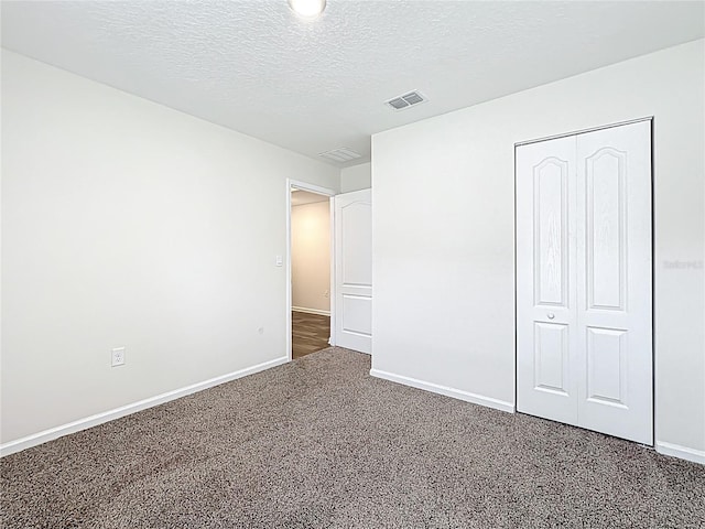 19 Roxland Ln, Palm Coast, FL 32164 - unfurnished bedroom featuring baseboards, carpet flooring, a textured ceiling, and visible vents
