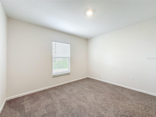19 Roxland Ln, Palm Coast, FL 32164 - unfurnished room with baseboards, carpet flooring, and a textured ceiling