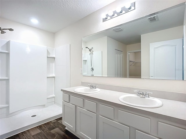 19 Roxland Ln, Palm Coast, FL 32164 - full bathroom with a shower, a sink, wood finished floors, and visible vents