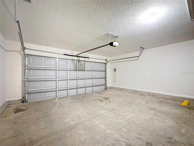 19 Roxland Ln, Palm Coast, FL 32164 - garage featuring baseboards and a garage door opener