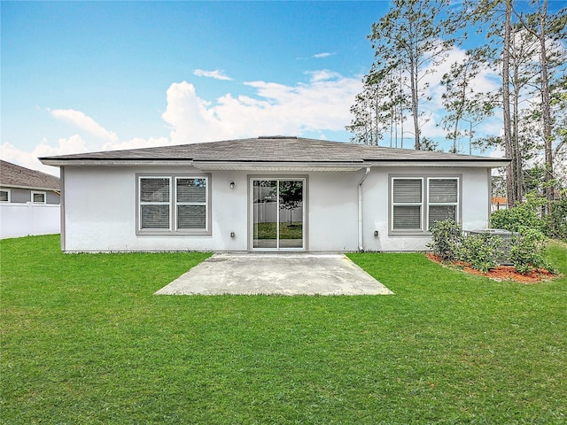 19 Roxland Ln, Palm Coast, FL 32164 - back of house with fence, a patio, stucco siding, and a yard