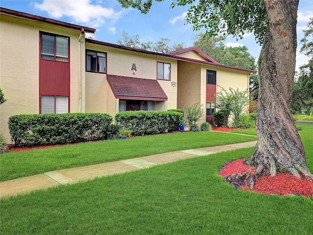 700 Midway Dr Unit B, Ocala, FL 34472 - townhome / multi-family property featuring a front lawn and stucco siding