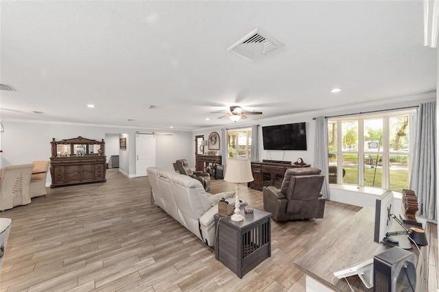 living area featuring crown molding, ceiling fan, recessed lighting, and light wood-style flooring
