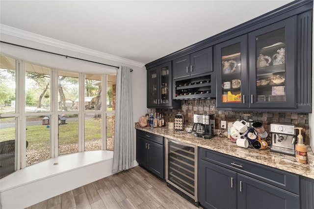 bar with ornamental molding, wine cooler, light wood-style floors, tasteful backsplash, and a dry bar