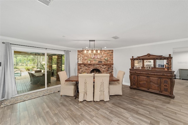dining space featuring visible vents, light wood finished floors, and crown molding