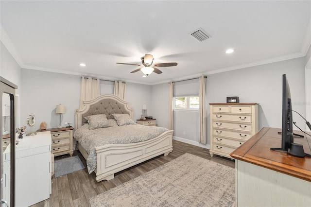 bedroom with visible vents, ornamental molding, and wood finished floors