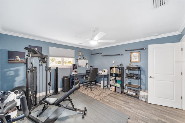 office with ceiling fan, visible vents, wood finished floors, baseboards, and ornamental molding