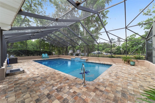 outdoor pool with a patio, a jacuzzi, and glass enclosure
