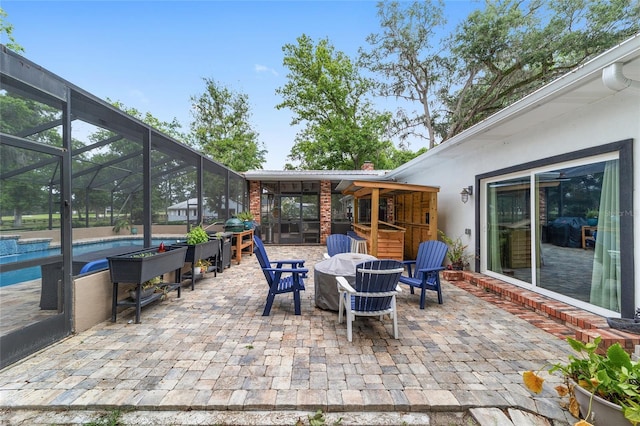 view of patio with glass enclosure, an outdoor pool, and outdoor dining space