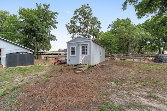 view of shed with fence