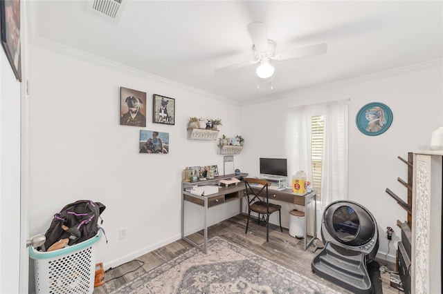 office featuring visible vents, ornamental molding, baseboards, and wood finished floors