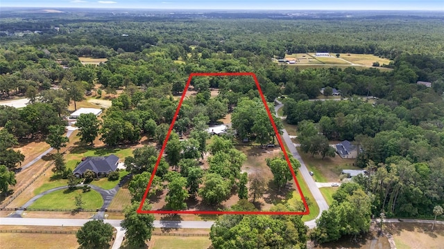 birds eye view of property with a forest view