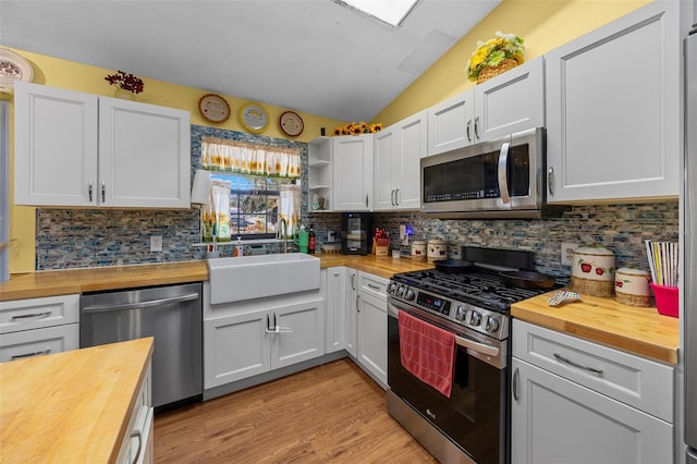 408 Etheredge St, Bushnell, FL 33513 - kitchen with wood counters, stainless steel appliances, a sink, and lofted ceiling