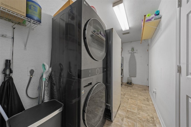 408 Etheredge St, Bushnell, FL 33513 - washroom featuring stacked washer and clothes dryer, light stone finish floors, and baseboards