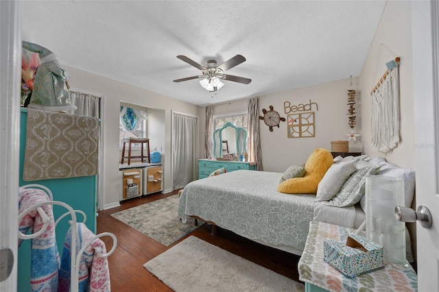 408 Etheredge St, Bushnell, FL 33513 - bedroom with dark wood-style floors, a textured ceiling, and a ceiling fan