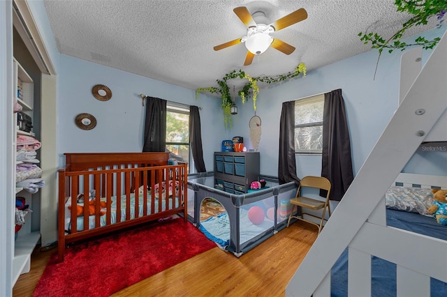 408 Etheredge St, Bushnell, FL 33513 - bedroom featuring wood finished floors, a textured ceiling, and ceiling fan